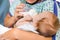 Mother Feeding Milk From Bottle To Newborn Baby