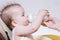 Mother feeds baby from a bottle of milk