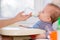 Mother feeds baby from a bottle of milk