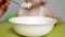 Mother feeds her baby oatmeal, close-up, child nutrition, breakfast, caucasian