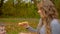 A mother feeds her pizza a little boy. Family picnic in autumn Park.