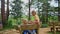 Mother Feeds with Spoon Little Girl on Wooden Bench in Park