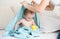 Mother found her baby under blue towel playing with yellow rubber duck