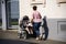 Mother german people push stroller carriage with baby on footpath