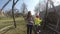 Mother with girl child swinging on retro wooden swing in early spring