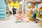 Mother with girl choosing baby potty in kids store