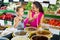 Mother with girl picking olives in food shop