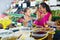 Mother with girl picking olives in food shop