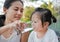 Mother giving glass of water to her child.