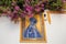 Mother of God on colorful tiles at entrance of the andalusian church with flowers around