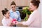 mother and grandmother presenting gift and flowers