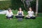 Mother, grandmother and teen daughter practicing online yoga class outdoors