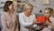 Mother and granny giving present to school girl, encouraging to study well