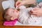 Mother hands cleaning eyes of baby with cotton