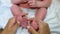 Mother hands holding cute tiny little baby feet feeling love and tenderness enjoying motherhood. Baby kid feet in parent