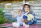 Mother in hat and whining child girl in countryside