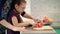 Mother help daughter to cut apple on cutting board. Mom hand cooking with kid