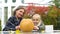 Mother helping child to carve pumpkin Jack for Halloween, autumn party, fun