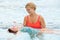 Mother Helping Daughter To Float on Her Back