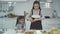 Mother is helping her daughter to break the egg for Bakery preparation in home kitchen.