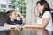 Mother Helping Son With Homework At Table