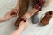 Mother helping son to tie shoe laces at home, closeup