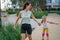 Mother helps daughter learn to roller skate.