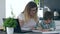 Mother helps son to paint with colored felt-tip pens image sitting in kitchen