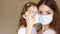 Mother and her baby girl medical mask. Close up portrait young woman and daughter. Health care and medical concept