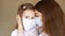 Mother and her baby girl medical mask. Close up portrait young woman and daughter. Health care and medical concept
