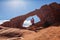 Mother with her baby son stay below Skyline arch in Arches National Park in Utah, USA