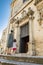 A mother and her child climb the steps and enter the church