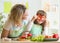 Mother and her child preparing healthy food and