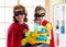 Mother and her child in Superhero costume. Mum and kid ready to house cleaning. Houseworking and housekeeping.