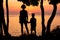 Mother and her child watching beautiful sunset on the seashore