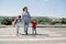 Mother and her children crossing road