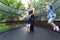 Mother and her children on garden trampoline cheerfully spend time