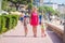 Mother with her children go to sea beach during tropical rest