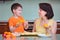 Mother and her cute little boy baking muffins