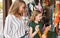 Mother and her daughter choosing toys in shop