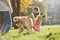 Mother with her daughter have walk with Golden Retriever dog in the park