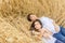 Mother with her daughter lies in a wheat field in summer. Solitude of the mother with the child.