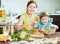 Mother with her daughter making a wonderful fish dumplings in t