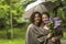 Mother with her daughter in the Park in the rain together under an umbrella. Famely.