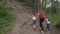 Mother with her daughters embarks on a journey. A family of tourists up the hill on the forest path