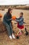 Mother and her disabled daughter spend time on a pumpkin field.