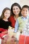 Mother With Her Family Holding Christmas Gifts