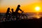 Mother and her kids on the bicycle silhouettes