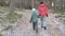 Mother and her little daughter walking through a snowy forrest. Steadicam.