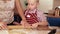 Mother and her little helper in the process of making a cake